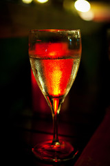 Glass with wine in red backlight