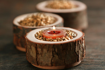 Burning wooden candle with sea salt, closeup