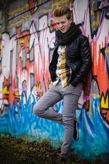 Fashion male portrait on graffiti wall