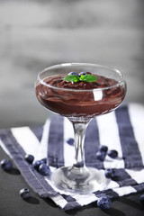 Chocolate mousse with fresh berries on wooden background