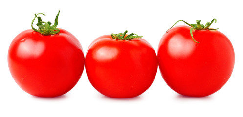 three fresh tomatoes with green leaves isolated on white background