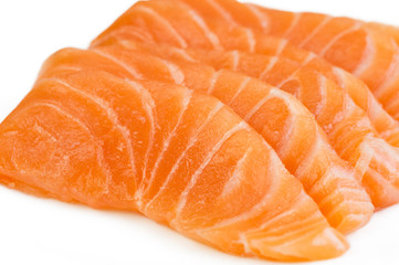 Sliced raw salmon isolated on white background
