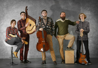 Musical band on grey wall background