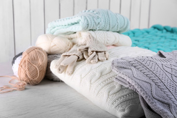 Knitted wool plaid  and clothes on light background