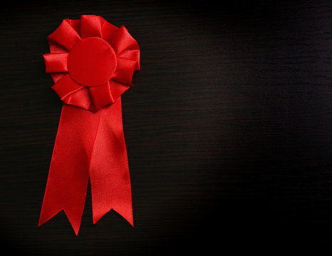 Award ribbons on dark wooden background