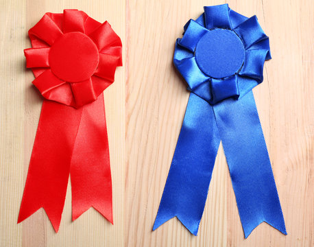 Award ribbons on wooden background