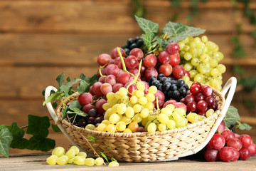 Grape in basket on wooden table