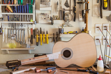 Classical guitar under construction in luthier workshop - obrazy, fototapety, plakaty