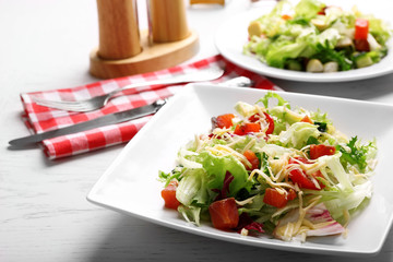 Tasty salmon salad on wooden table background