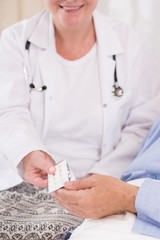 Patient taking pills from nurse