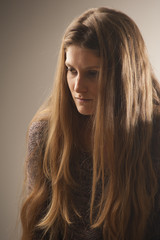 Fototapeta premium Portrait of young wooman with long hair. Vintage style.
