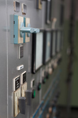 Old power plant control panel with switches and instruments