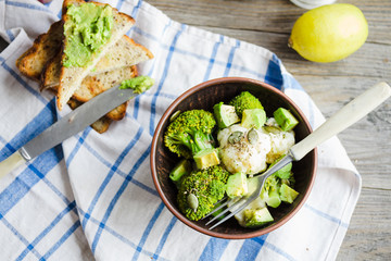 Winter vegetable salad with broccoli and cauliflower, toast with