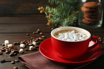 Mug of hot chocolate with marshmallows, on wooden background