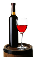 Red wine in glass and in bottle standing on barrel isolated on white