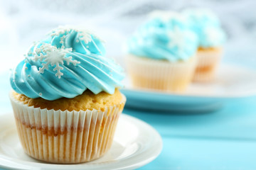 Blue cakes on plate on wooden background