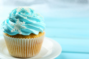 Blue cake on plate on wooden background