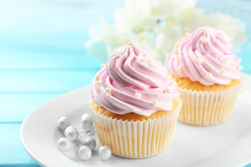 Pink cupcakes on wooden background