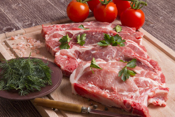 Fresh raw pork chop meat on cutting board