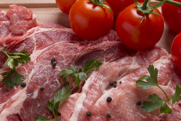 Fresh raw pork chop meat on cutting board