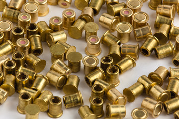 heap of shotgun primers on white background