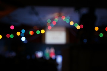 Blur colorful christmas lights bokeh on party background