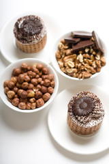 Cake composition with nuts on the dish isolated on the white backing