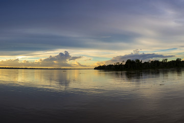 Colorful sunset on the river Amazon in the rainforest, Brazil