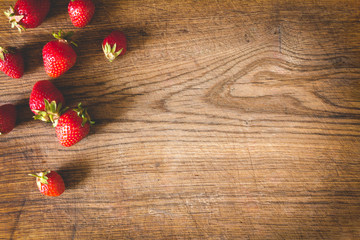 Fototapeta na wymiar Fresh strawberries on old wooden background