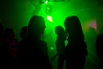 Two womens dancing at the night club