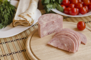Slices of ham on a wooden board