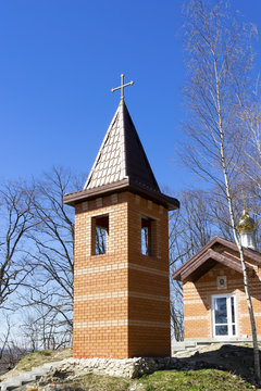 Christian Orthodox chapel made of brick, with a cross on the roof
