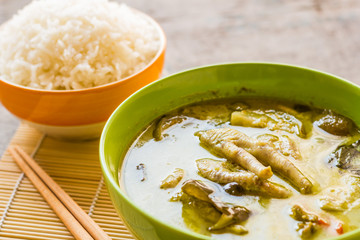 Thai chicken green curry in bowl and cooked rice