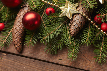 Christmas tree branch, stars, cones, balls on the background of
