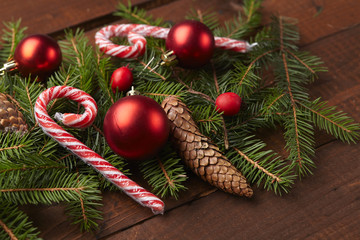 Fototapeta na wymiar Christmas tree branch, candy, cones, balls on the background of