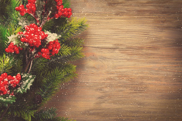 Christmas fir tree branches with rowan on wooden table
