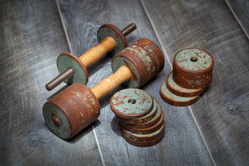 Movable metal dumbbell. With the ability to adjust the weight and load. Rusted vintage dumbbell in...