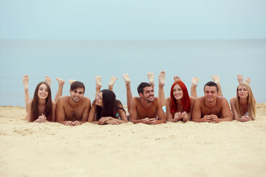 Beautiful Young People Lying On Beach