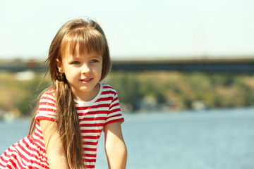 Little girl on the riverside