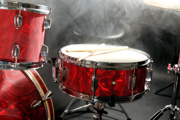 Drum set in smoke on a stage