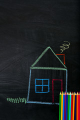 Funny composition of office supplies and pictures drawn with chalk on blackboard