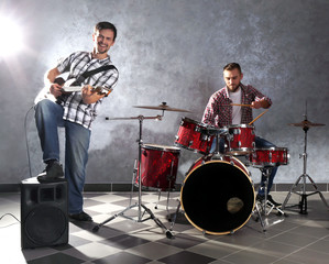 Fototapeta na wymiar Musicians playing the drums in a studio