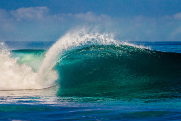 Surfing waves at Bonzai Pipeline on the North Shore of Oahu, Hawaii