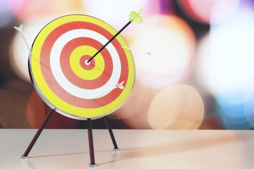 Bull's-eye with arrows on white table