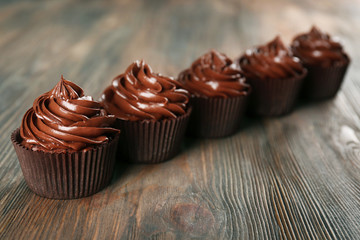 Chocolate cupcakes on dark wooden background