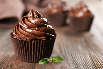Chocolate cupcakes with mint on wooden table