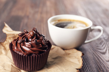 Chocolate cupcakes and coffee on craft paper