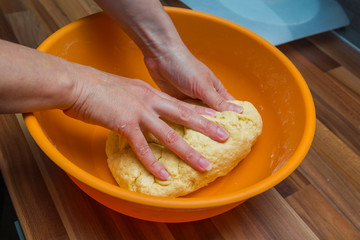 The process of cooking yeast dough for lemon pie with hands.