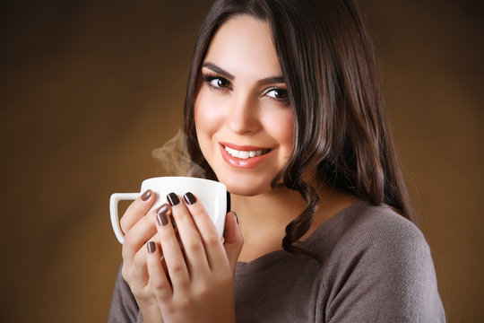 Portrait of smiling pretty woman with cup of coffee