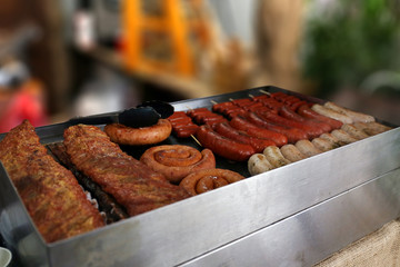Smoked sausages on grill inside